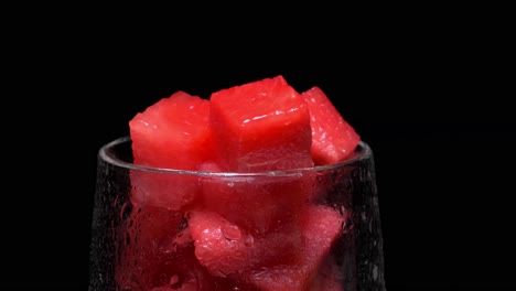 Red-cubes-of-watermelon-in-a-wet-glass