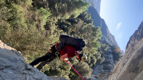 you adventurer climber trekking alone rock mountains in natural scenic landscape with rope and safety helmet