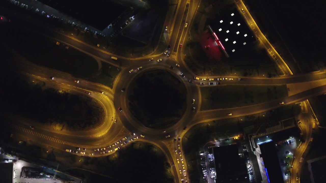 Free stock video - Turning around a roundabout aerial drone night shot.