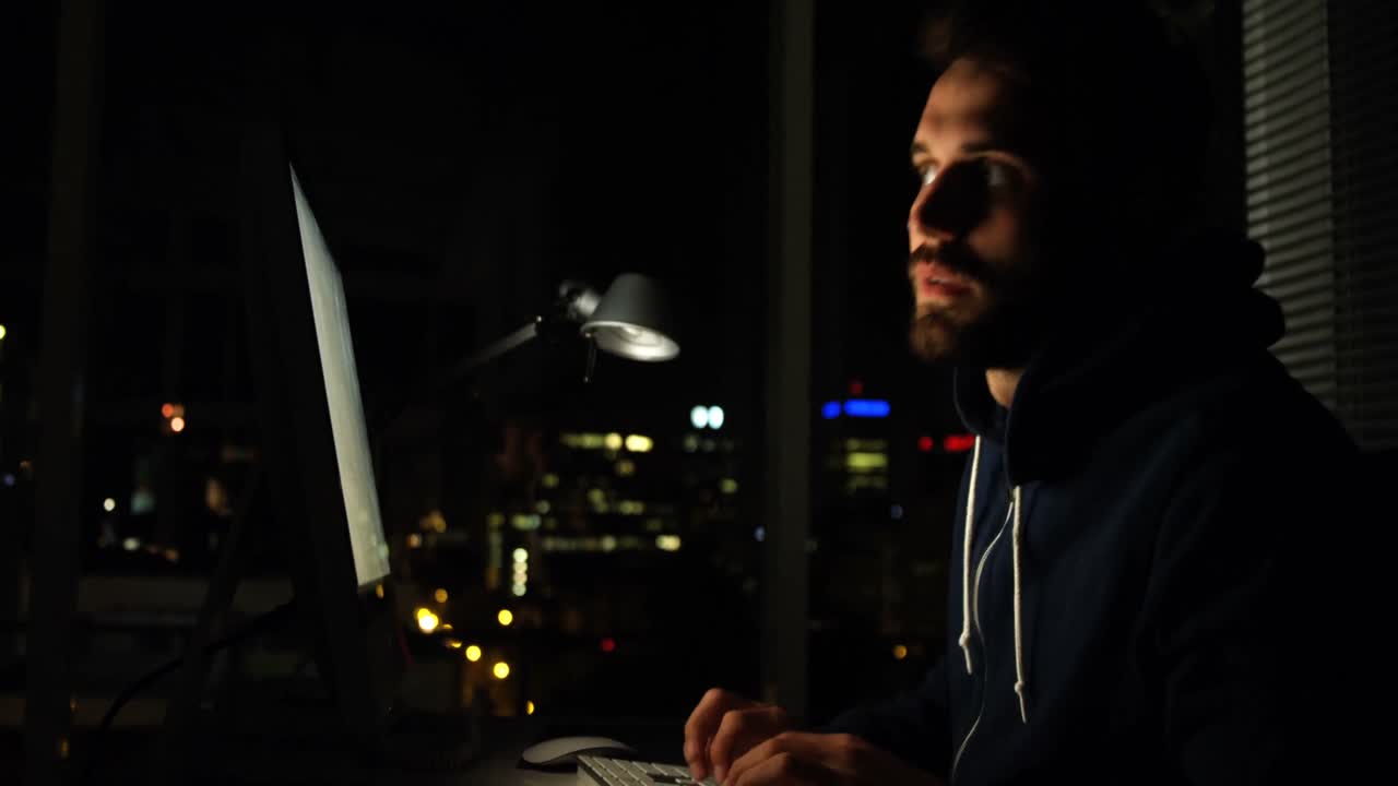 Hacker using computer at night