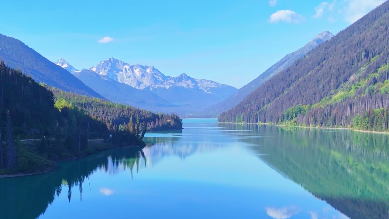 Breathtaking aerial view of a pristine glacier lake surrounded by majestic mountains in Canada