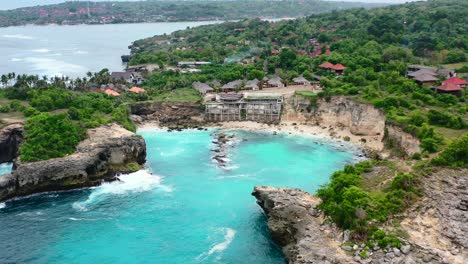 aerial-of-empty-Blue-Lagoon-in-Nusa-Ceningan-Island-in-Indonesia-on-cloudy-day