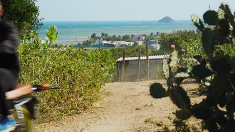 Young-man-rides-motorbike-on-beach-in-My-Hoa,-Vietnam-kitesurfing-destination