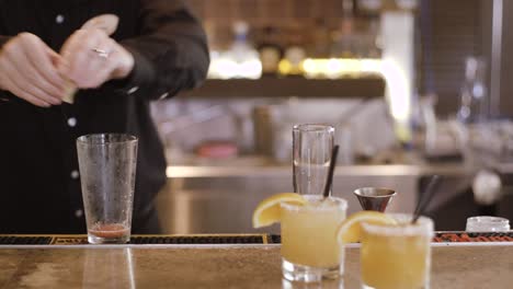 expert barman is making cocktail at night club.