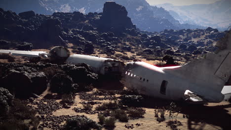 plane wreckage lying amidst rocky terrain after a crash near mountains