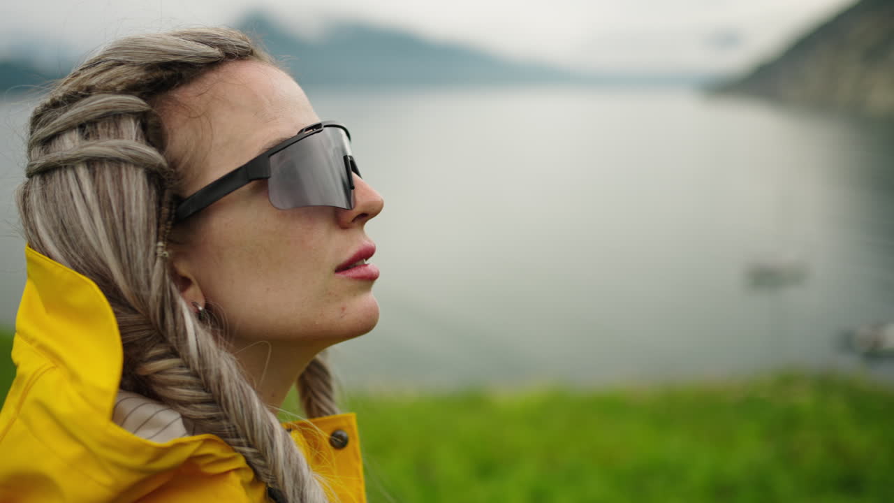 Woman in Raincoat by the Lake