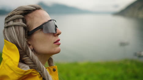woman in raincoat by the lake