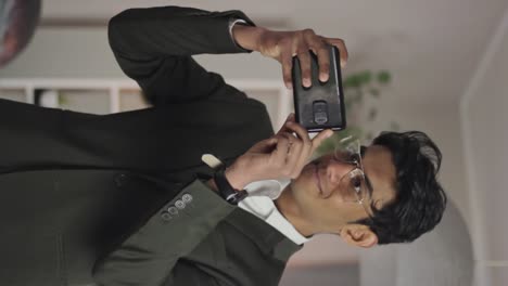 vertical shot of real estate agent taking pictures of house to sell, static