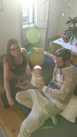 happy family feeding baby