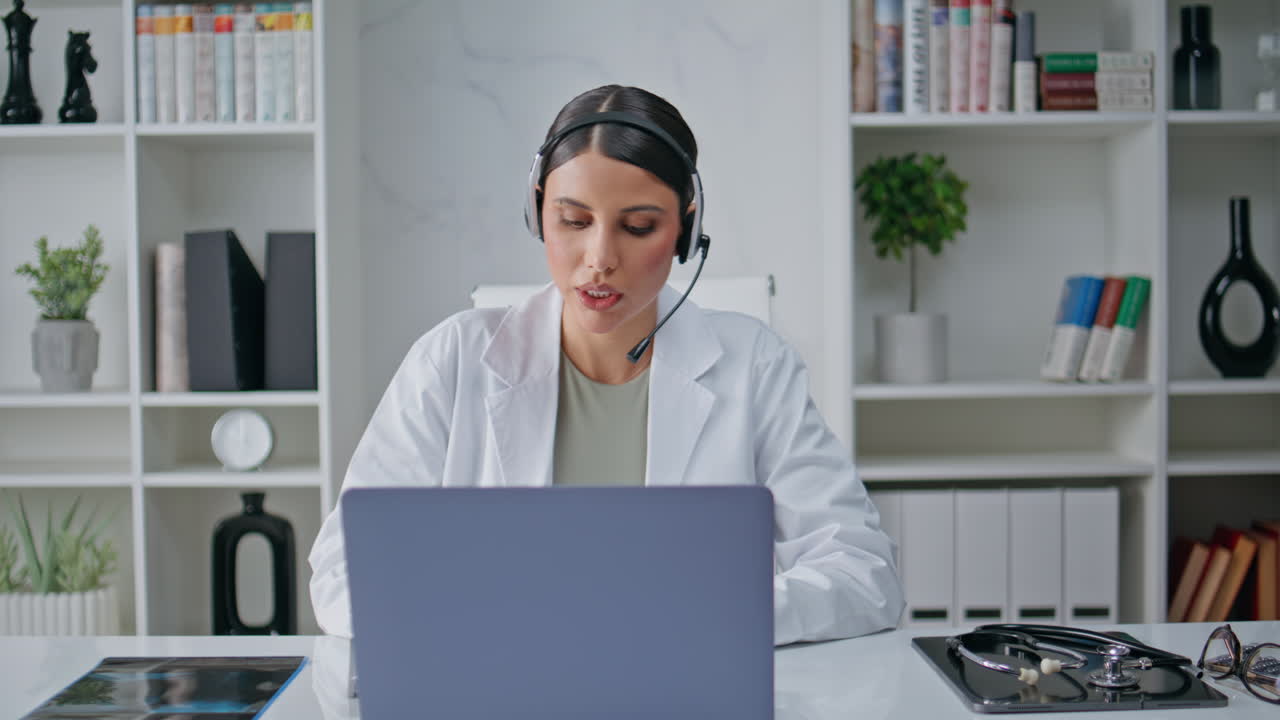 Health specialist talking headphones at clinic laptop closeup. Woman consulting