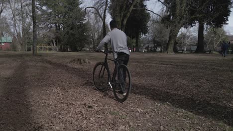 Man-checking-if-the-bike-is-working-or-broken-down-by-moving-the-pedals