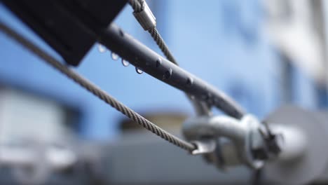 close-up of a metal cable hook with water droplets