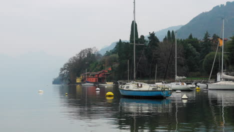 sailboats on the coastline near bellagio, lake como, italy