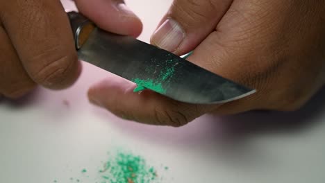 Footage-of-hands-slowly-sharpening-a-pencil-and-some-coloured-pencils-with-a-sharp-knife