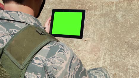 military soldier using digital tablet during training exercise