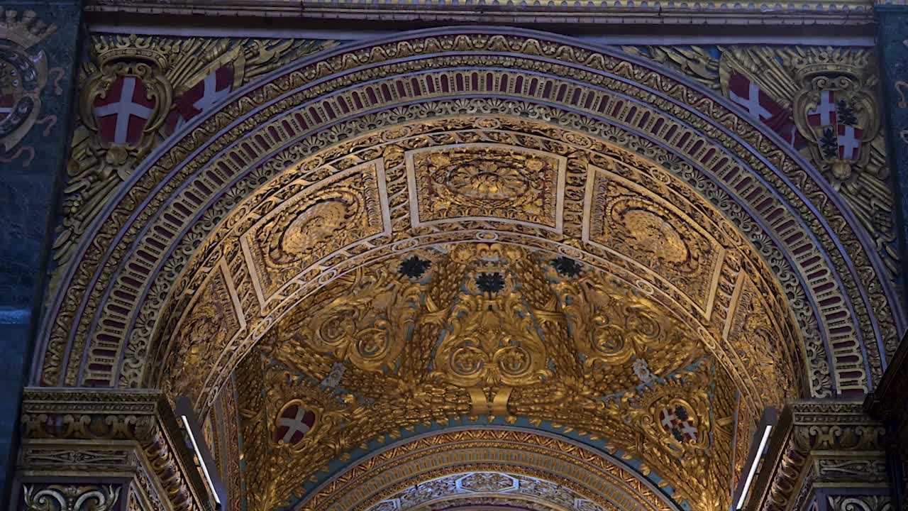 The golden arch inside St John’s Co-Cathedral shines with intricate baroque detail, symbolising faith, artistry, and Malta’s rich spiritual heritage