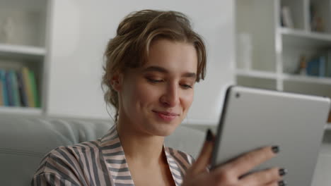 employee having video call at home office closeup. girl using pad in living room