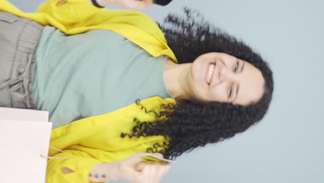 Vertical-video-of-Young-woman-shopping-on-the-phone.