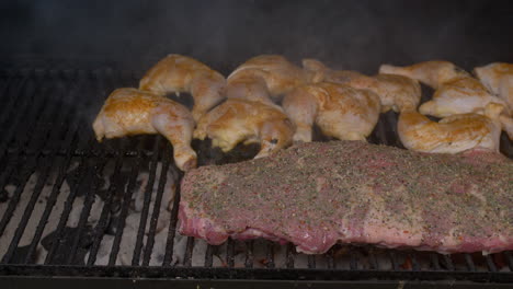 tilt down to bbq ribs and chicken thighs on hot grill