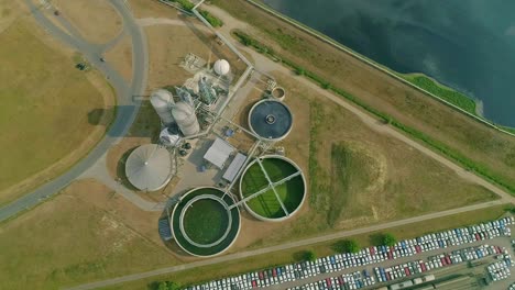 drone view of detailed layout of a state-of-the-art water treatment plant, featuring circular filtration tanks and advanced environmental engineering structures