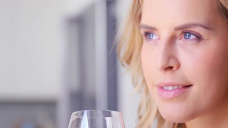 Close-up-of-women-holding-a-glass-of-white-wine
