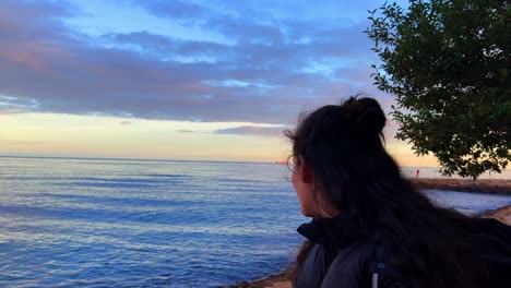 beautiful lady looking at the sea in alicante, spain during the day