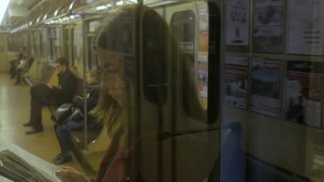 woman reading a notebook in a subway