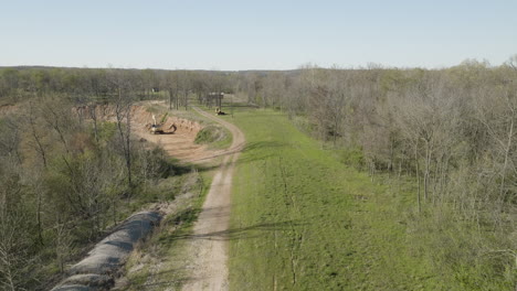 construction site in the forest with excavator, concept deforestation, aerial