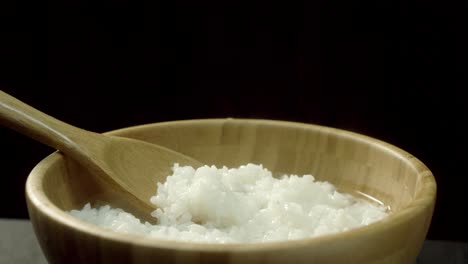 hot cooked rice in wooden bowl