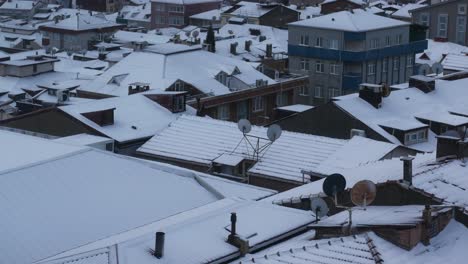 snowy city roofs