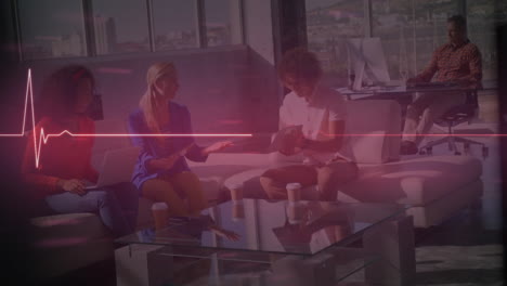 animation of heart rate monitor over group of diverse colleagues discussing together at office
