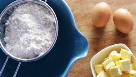 various ingredients and brown eggs on wooden table 4k