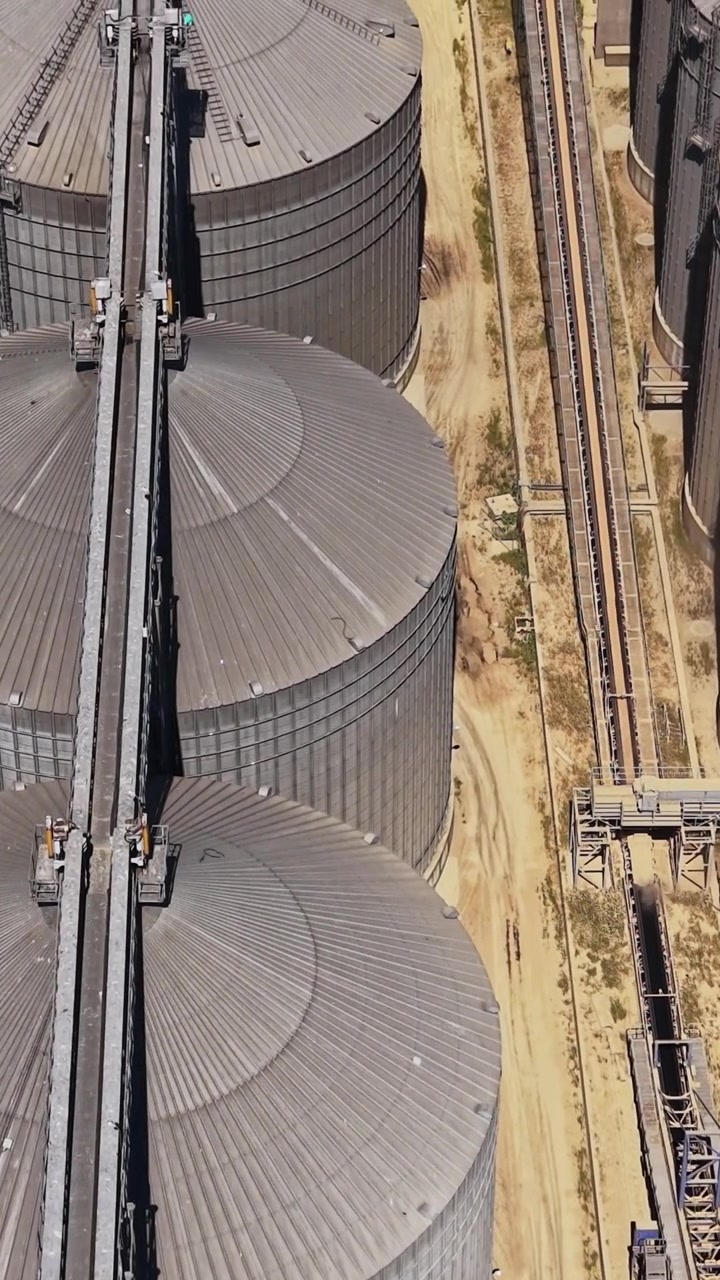 Construction of grain storage silos at industrial site in city