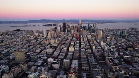 aerial view tilting over the cityscape of san francisco, pink dawn in ca, usa