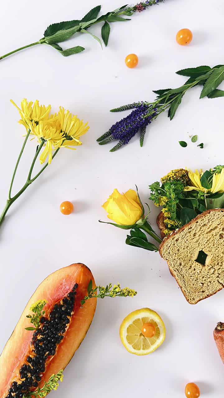 Colorful Still Life Arrangement with Flowers, Fruit, and Food