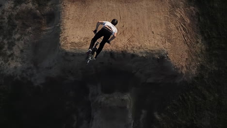 extreme sports bmx backflip on a large dirt jump course