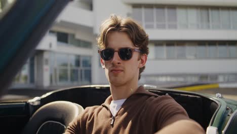 man in vintage car