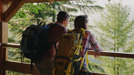 A-Couple-Of-Tourists-Admire-The-Beautiful-View-Of-The-Forest-From-The-Observation-Deck-At-Sunset-4K-