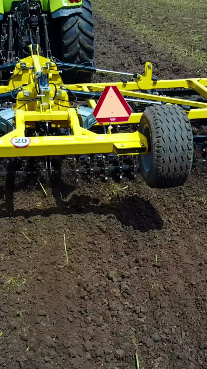 Tractor Working In The Agricultural Field. Agricultural equipment ready for ploughing the fields Vertical video