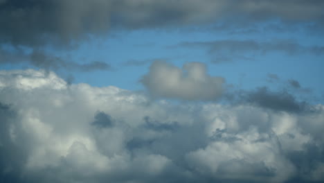 cumulonimbus clouds developing with darker cloud layer in front