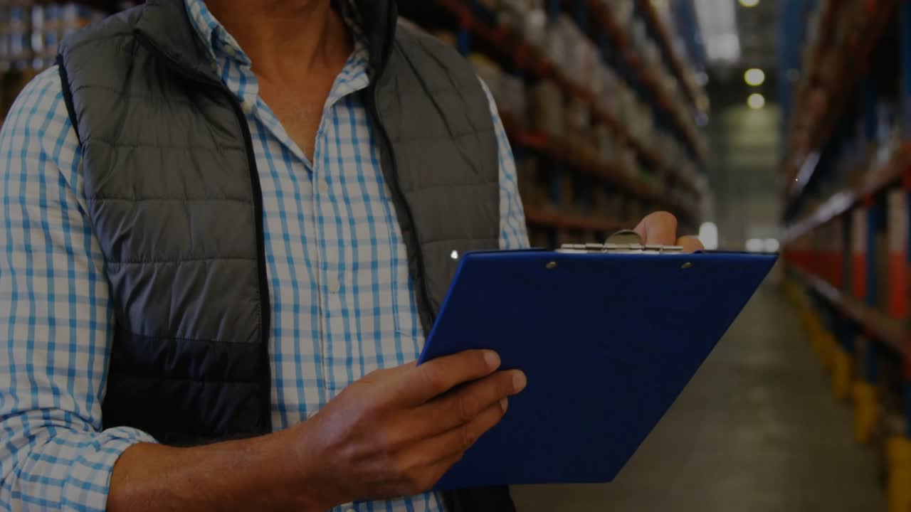 Worker starting warehouse check with clipboard pen donning helmet network overlay growing over man