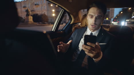 Man-recording-message-on-phone-at-remote-workplace.-Working-businessman-in-car