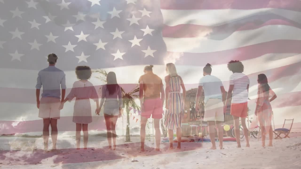 American flag waving against rear view of group of friends jumping on the beach