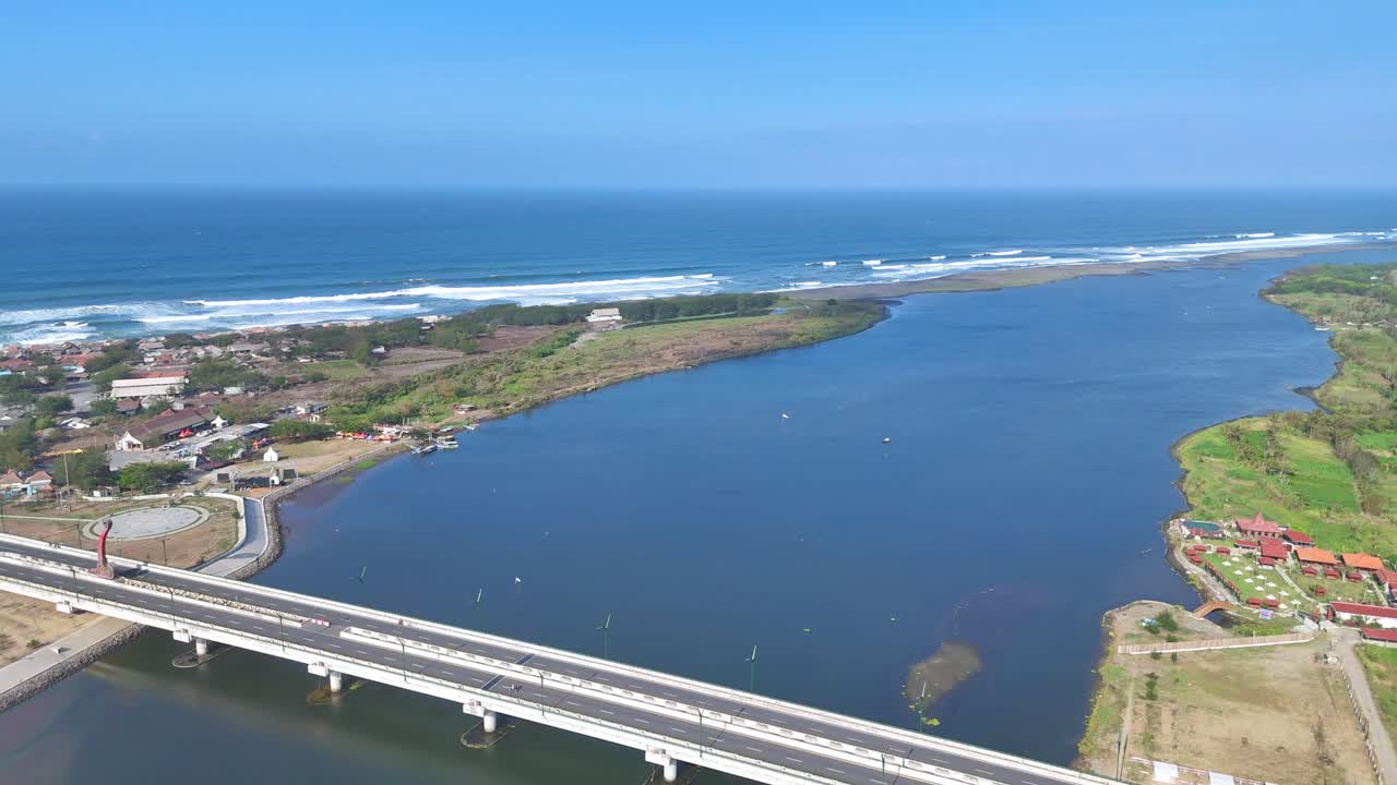 DRONE. Aerial view of bridge over canal near beach. Big white bridge and coastline on the background. 4K drone view.
