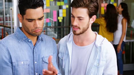 male executives having discussion over laptop