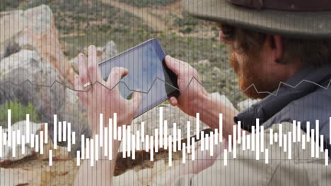 Animation-of-data-processing-over-caucasian-male-hiker-with-tablet-in-mountains