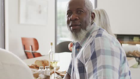 Portrait-of-happy-senior-diverse-people-having-dinner-at-retirement-home