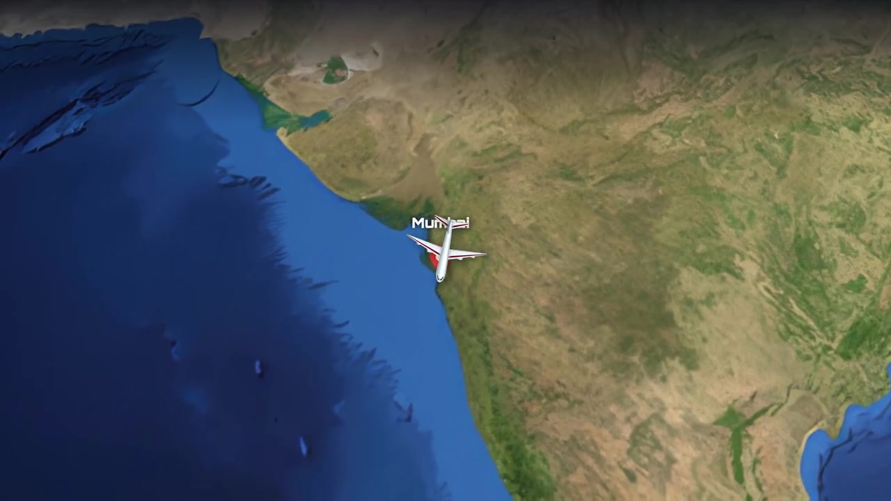 Satellite view animation follows a commercial airplane flying from Los Angeles to Mumbai across Earth
