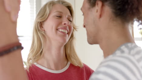 happy diverse couple looking at each other and dancing at home, slow motion