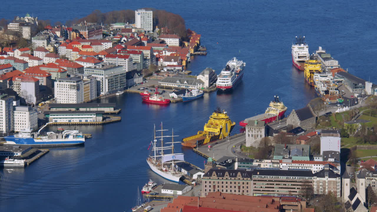shot of the harbour area in Bergen with cruise ship tall master ship and commercial shipping. Filmed from Fløyen Panorama